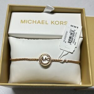 NEW Michael Kors bracelet. NWT. Adjustable. Rose gold. Signature logo